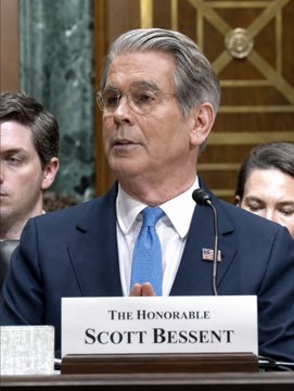 Treasury Secretary Scott Bessent speaks at a Senate hearing, with a nameplate reading "The Honorable Scott Bessent," as he discusses potentially expanding U.S. debt buybacks to more than $4 billion per issue, as referenced in the accompanying post.
