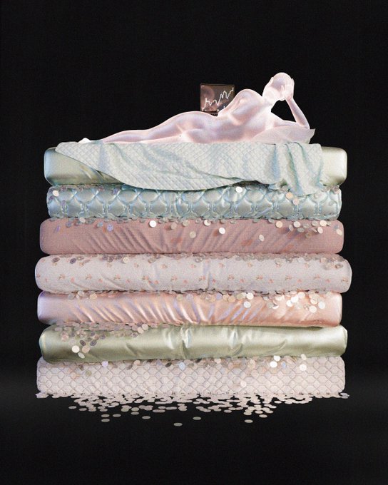 A stack of decorative pillows and cushions in pastel colors (green, pink, cream, white) against a black background with confetti scattered at the base.