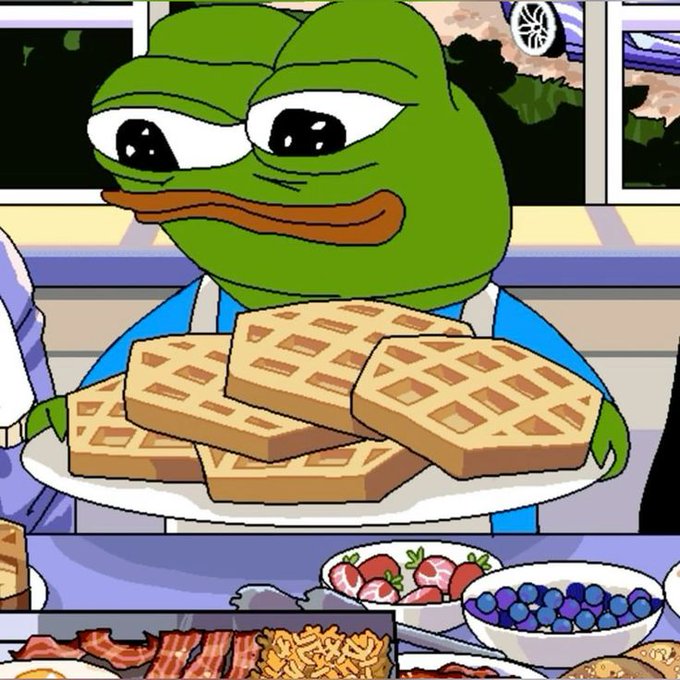 The image features a cartoon frog holding up waffles with its mouth open as if saying "waffle time!". In front of the frog, there's a plate full of food including waffles, fruit (blueberries), and bacon. The background shows a dining table with various dishes on it, suggesting that this is a breakfast scene. The post caption reads: "GM frens, what are we all having for breakfast?".
