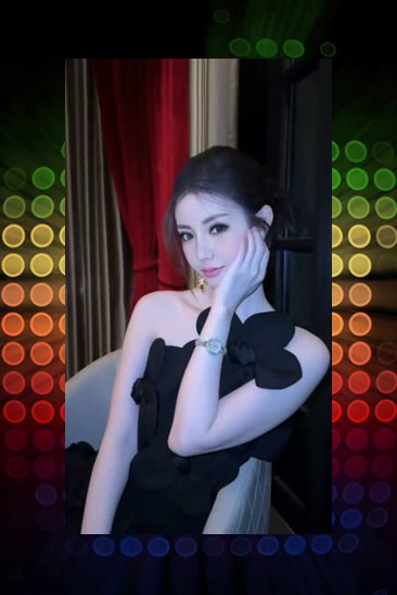 A photograph of a young woman in a black ruffled dress posing elegantly with her hand near her face, framed by a colorful dotted light pattern background.
