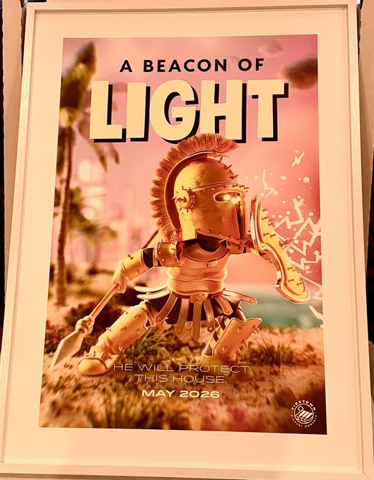 The image features a poster with a cartoon character wearing a gold helmet, holding a sword and shield, and standing next to a palm tree. The poster has a message that reads "A Beacon of Light" and includes an announcement for a special event on May 2026.