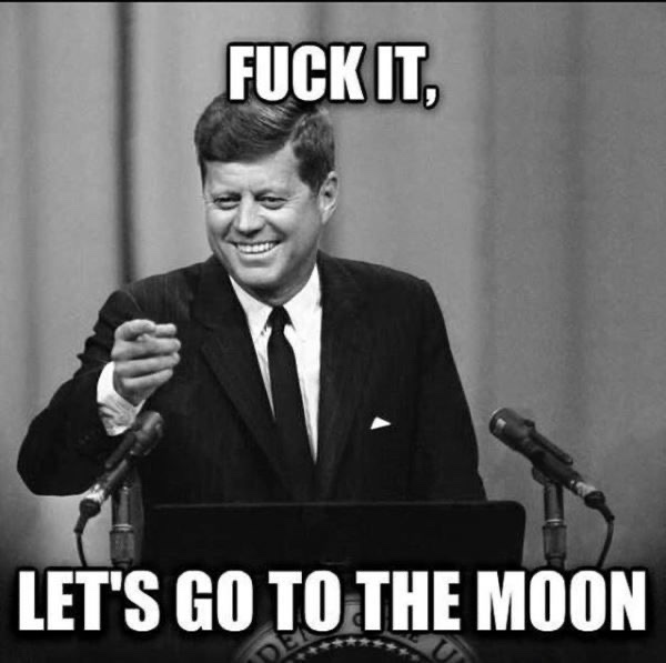 A black-and-white photo of John F. Kennedy smiling at a podium with text overlaid reading 'FUCK IT, LET'S GO TO THE MOON'.
