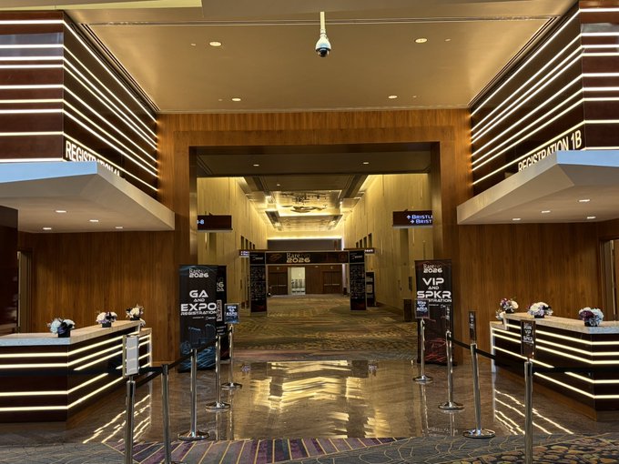 A photograph of an upscale hotel or casino lobby entrance featuring reception desks, stanchions, and signage for the 'Luxon Poker' GA Expo 2026 and VIP Speaker events.