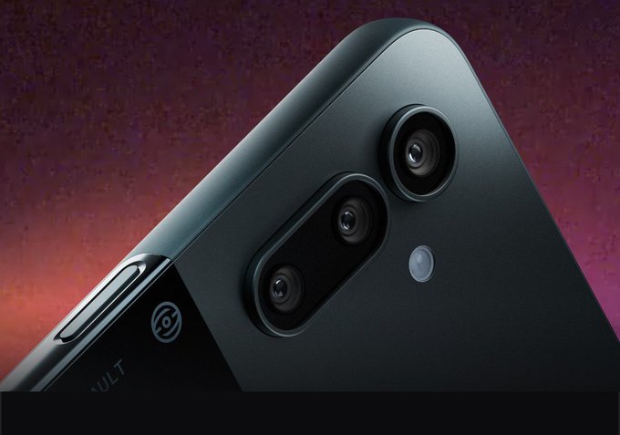 Close-up of a dark-colored smartphone's rear camera module showing multiple lenses and the word 'VAULT' partially visible on the side.