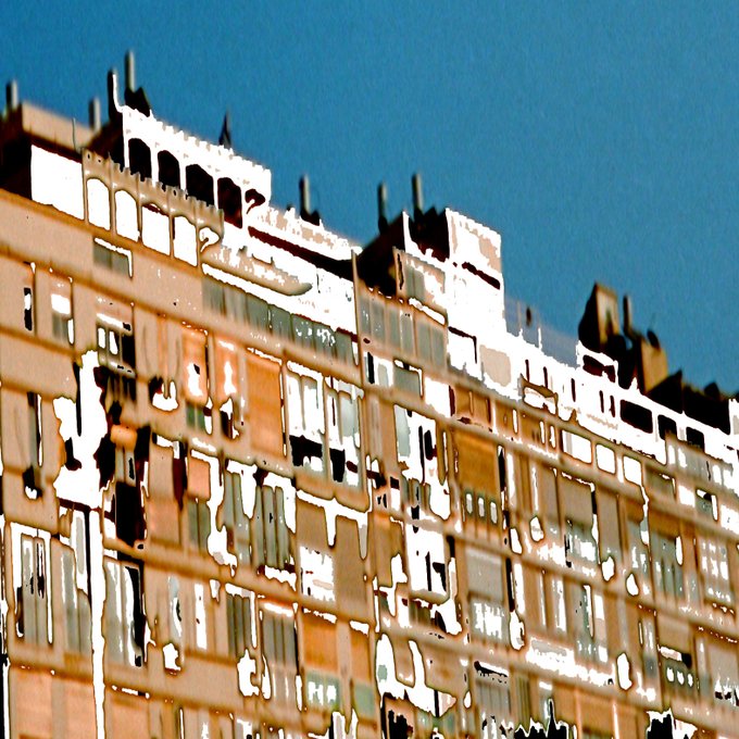 A stylized image of a brown apartment building against a blue sky, with a distorted, painterly visual effect applied throughout the scene.