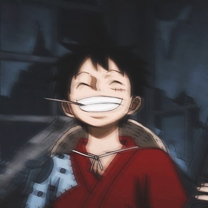 A cheerful anime character with spiky black hair and a wide grin holds a stick in his teeth, wearing a red robe with a fur-lined collar and a small cross-shaped scar under his eye. The image, a popular meme known as "Monke," relates to the post's playful "gm" (good morning) greeting to fellow NFT enthusiasts, conveying a friendly and enthusiastic vibe.