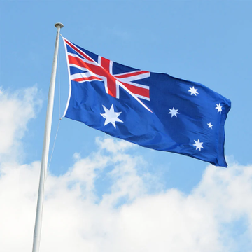 The image shows the Australian flag waving against a blue sky with white clouds. This relates to the post as it depicts the national flag of Australia, which represents the country whose financial regulator (ASIC) is implementing the crackdown on unlicensed crypto firms mentioned in the accompanying text.