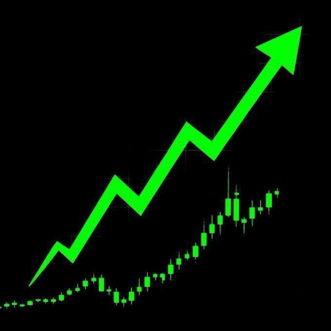 A green candlestick chart with a large upward-pointing arrow on a black background, indicating bullish price movement.