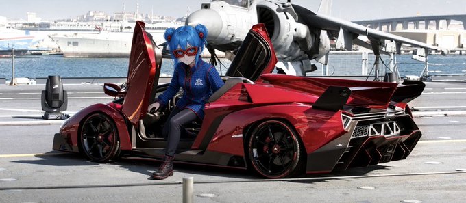 A cosplayer with blue hair in twin buns wearing a blue and black bodysuit sits in the open door of a red chrome sports car on a pier, with fighter jets on an aircraft carrier in the background.