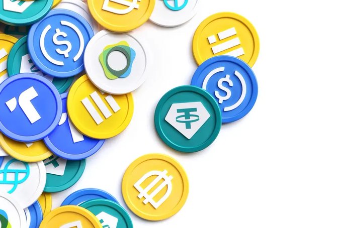 A pile of colorful cryptocurrency coins featuring symbols for USD, Tether, and other digital currencies on a white background.