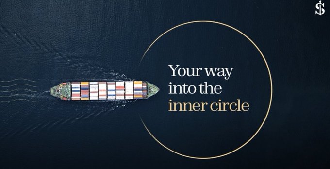 An aerial view of a container ship sailing on dark blue water, featuring a gold circle outline and text reading 'Your way into the inner circle' with a logo in the top right corner.
