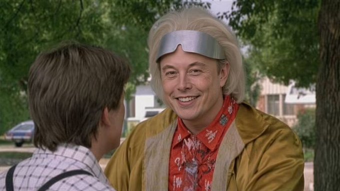 A still from Back to the Future Part II showing Doc Brown, wearing his futuristic silver visor and tan jacket, smiling at Marty McFly.