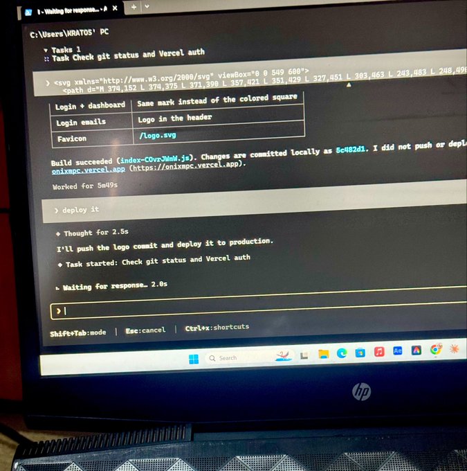 An HP laptop screen displays a terminal running an AI coding assistant that is deploying changes to production on Vercel.