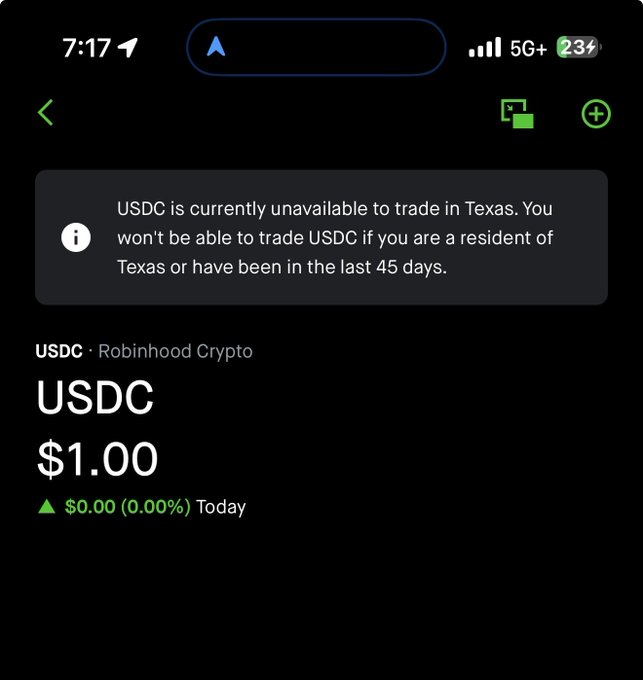 The image shows a phone screen with a message from someone named Greg Abbott, who has sent an email about Bitcoin trading. The message contains information about the current status of Bitcoin trading in Texas, stating that USDC is currently unavailable due to trade restrictions in Texas. This restriction prevents users from trading Bitcoin in the state. The post also mentions that USDC is offering a Bitcoin exchange service for those interested in trading Bitcoins.