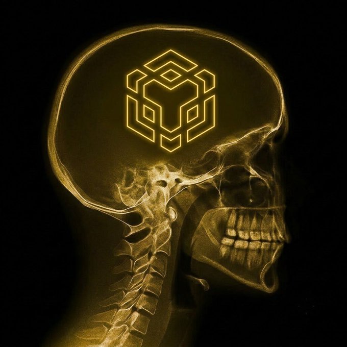 A glowing golden X-ray style image of a human skull in profile with a geometric logo/hex symbol illuminated inside the cranial area.