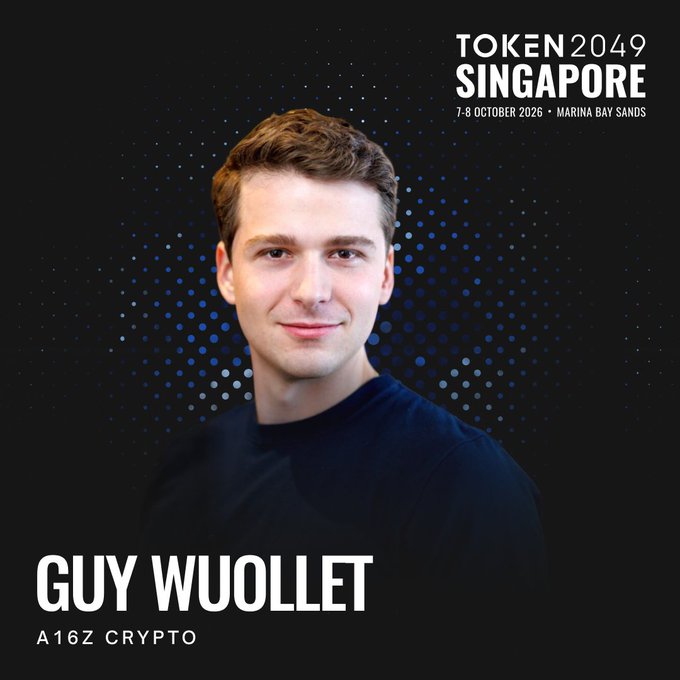 Promotional graphic for TOKEN2049 Singapore (7-8 October 2026, Marina Bay Sands) featuring a headshot of Guy Wuollet, General Partner at a16z Crypto, set against a dark blue dotted background.