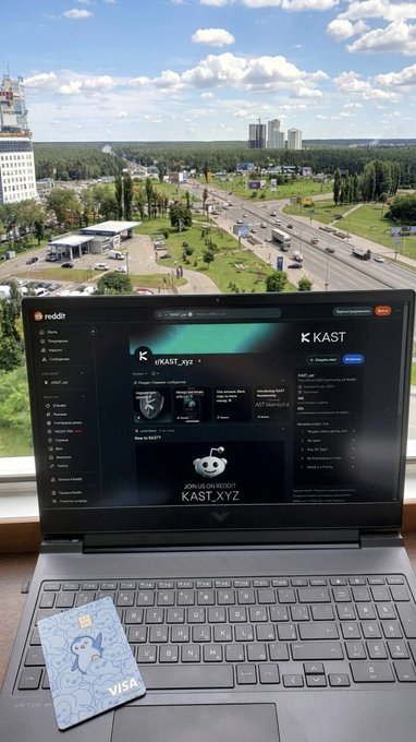The image features an open laptop computer with a credit card attached to its keyboard. The laptop screen displays a website called "reddit" along with a message that reads, "KAST is now on Reddit!". This suggests that the user has recently made a purchase or joined the KAST community and is now sharing their experiences or asking questions related to the platform.