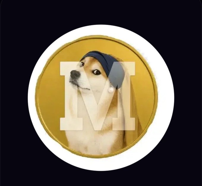 A circular profile picture featuring a Shiba Inu dog wearing a blue beanie against a gold background, with a translucent 'M' logo overlaid in the center.