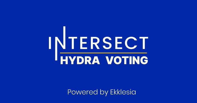 The image features a blue banner with white text that reads "Intersect Hydra Voting" against a gray background. The text also includes the words "powered by Eklesia", which suggests that this event is being sponsored or supported by someone named Eklesia. The image does not provide any additional information about the event, but it seems to be related to the 2026 budget process and Hydra voting.