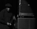 A small, blurry dark image shows a person in what appears to be a dimly lit setting near some equipment.