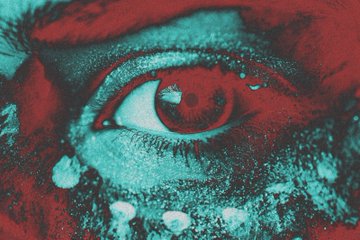 A close-up of an eye rendered in a grainy, high-contrast red and cyan duotone effect, giving it an unsettling, horror-like aesthetic.