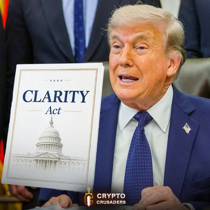 The image features a man wearing a suit, holding up a book titled "CLARITY ACT" with his hands. The title of the book suggests that it might be related to cryptocurrency or Bitcoin. The man appears to be speaking into a microphone, which could indicate that he is addressing an audience or participating in a press conference.

The post about crypto and Bitcoin also mentions that this act will be huge for crypto and $XRP, implying that there may have been significant developments or changes related to cryptocurrency regulations or policies under President Trump's leadership.