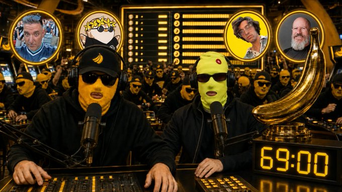 Two masked figures wearing balaclavas sit at a podcast console with microphones, surrounded by a crowd in black; a large golden banana and a digital clock reading '69:00' are prominently displayed, with circular portraits above showing various faces.