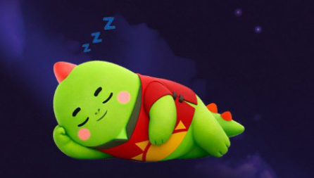 The image features a green dinosaur character that appears to be sleeping with its eyes closed. The dinosaur is wearing a red shirt and has a yellow bow around its neck, giving it a playful appearance. The background of the image is dark blue, which contrasts nicely with the vibrant colors of the dinosaur. There are also stars visible in the sky above the dinosaur, adding depth to the scene.