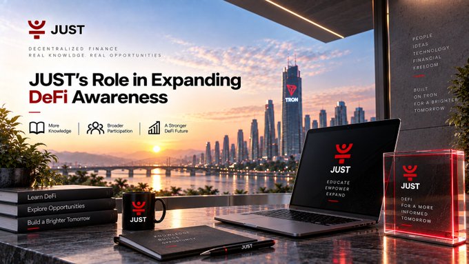 Promotional banner for 'JUST Decentralized Finance' titled 'JUST's Role in Expanding DeFi Awareness' featuring branded laptop, mug, and trophy against a city skyline.