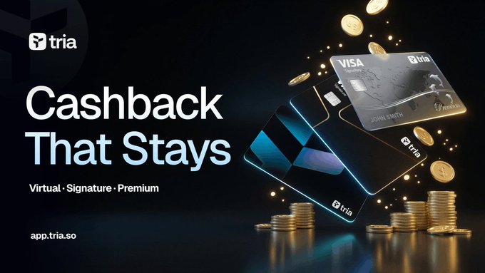 The image features a poster for Tria's Cashback That Stays feature. The poster displays three different types of payment cards - Visa, Mastercard, and American Express - along with some coins scattered around them. The text on the poster highlights that these payment cards can be used to make transactions across real-world financial activities, making digital money usable in various situations. The focus is on utility rather than holding value solely on-chain, as it combines Tria's card infrastructure and @useTria's card ecosystem for seamless transactions.