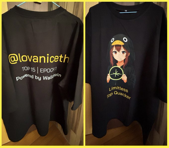 Two black T-shirts displayed side by side, one featuring '@lovaniceth TOP 15 | EPOCH 1 Powered by Wanchain' and the other showing an anime girl in a penguin hoodie holding a 'Limitless Top Quacker' symbol.