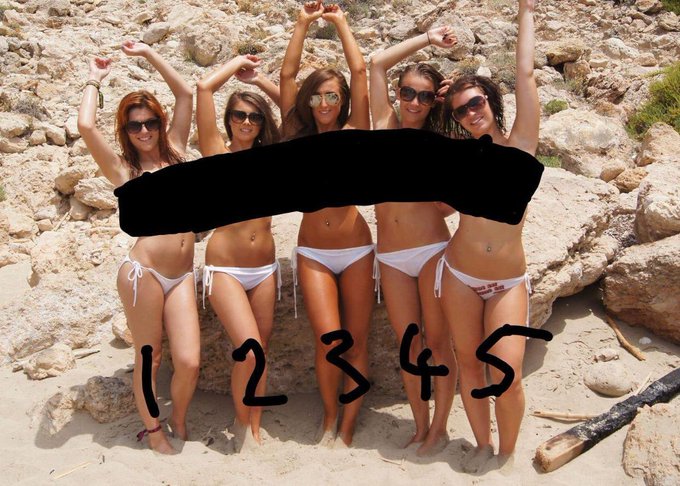 Five young women in bikinis stand in a row on a rocky beach with their arms raised; their torsos are blacked out and they are numbered 1 through 5.