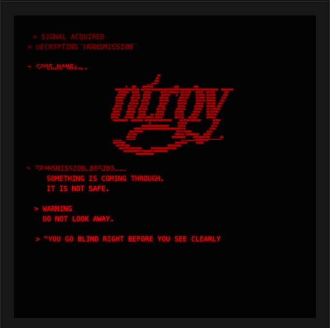 A dark digital screen with red text signaling a "DECKYPTY" transmission, displaying warnings like "SOMETHING IS COMING THROUGH. IT IS NOT SAFE" and "YOU GO BLIND RIGHT BEFORE YOU SEE CLEARLY."