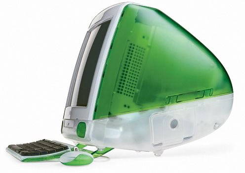 A green translucent iMac G3 vintage Apple computer with a matching keyboard and mouse on a white background.