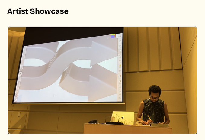 A presentation labeled 'Artist Showcase' shows a person standing at a podium in a large auditorium, working on a drawing tablet with their work displayed on a massive screen behind them.
