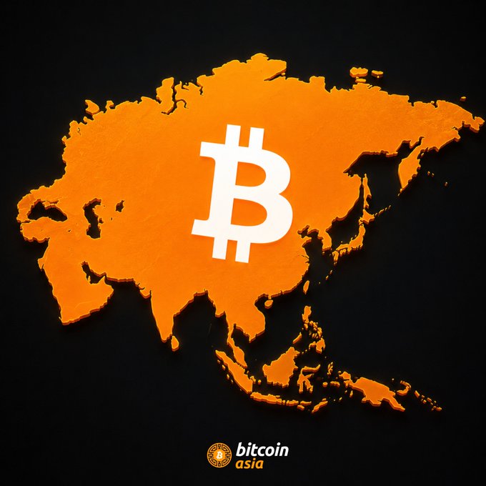 An orange 3D map of Asia on a black background with a large white Bitcoin symbol in the center and a 'bitcoin asia' logo at the bottom.