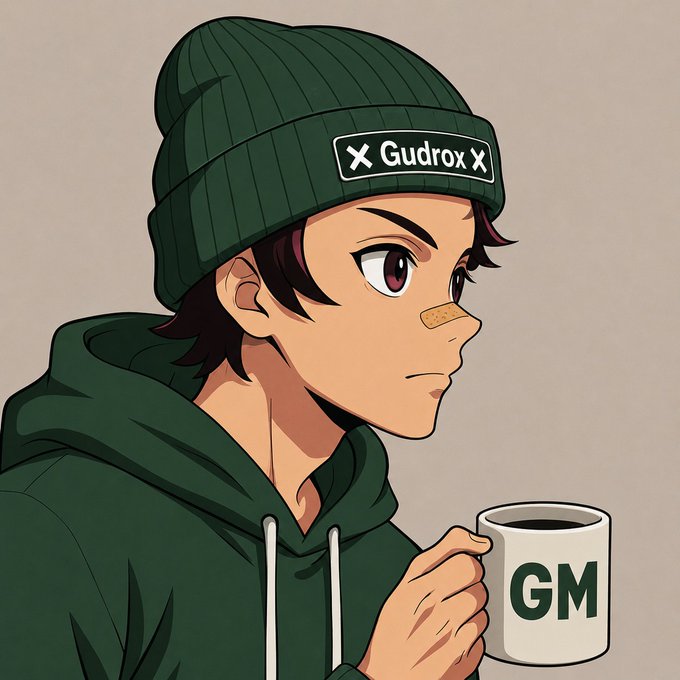 An anime-style illustration of a young man wearing a green beanie with a 'Gudrox' patch and a green hoodie, holding a white mug labeled 'GM'.