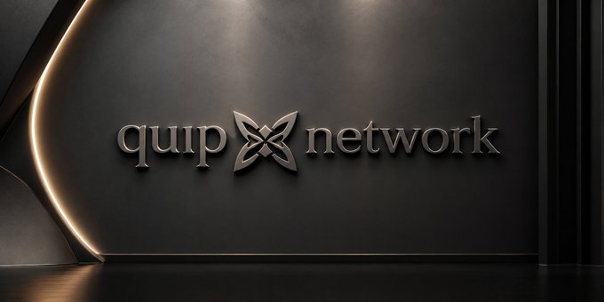 A sleek dark wall featuring the 'quip network' logo in metallic silver text with a stylized X symbol, illuminated by a warm orange light strip on the left side.