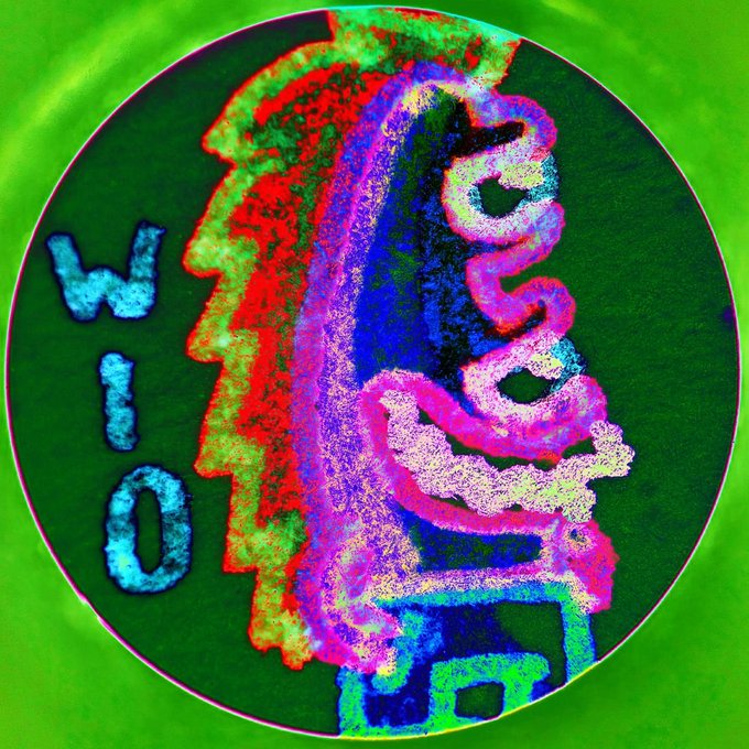 A psychedelic, neon-colored circular digital artwork featuring glitch-effect text reading 'Who owns the words' against a bright green background.
