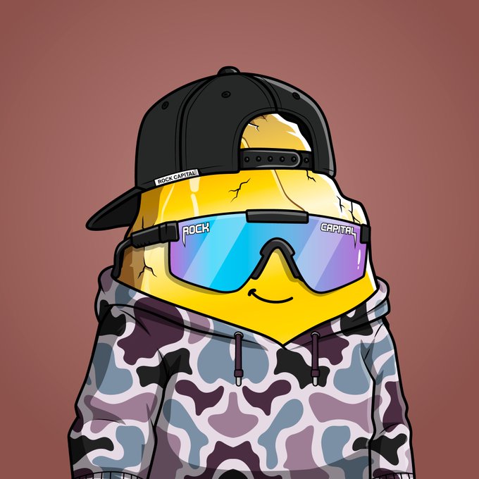 A cartoon illustration of a yellow lemon-like character wearing a black 'ROCK CAPITAL' cap, purple sunglasses with 'ROCK' and 'CAPITAL' on the lenses, and a camouflage hoodie against a red background.