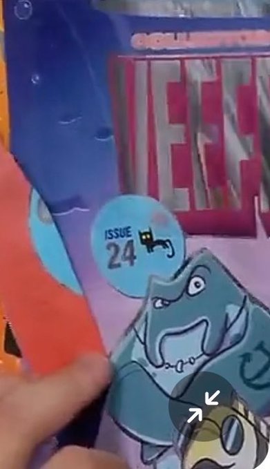 A hand holding a Marvel comic book (likely "WEST" based on partial text) showing a gray cartoon cat character with Issue 24 label and a small black cat symbol.