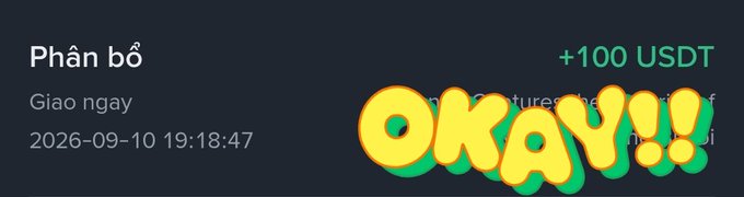 A digital notification screen displays "Phân bố" (Allocation) in Vietnamese with "+100 USDT" in green, overlaid with a large stylized graphic reading "OKAY!!!".