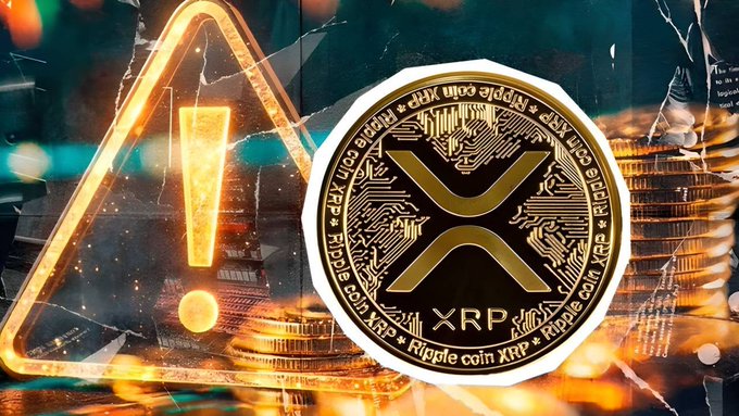 A close-up of a gold XRP (Ripple coin) with its distinctive X logo and 'Ripple coin XRP' text inscribed around the edge, set against a dark background with stacks of coins and a glowing warning triangle.