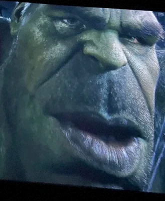 A close-up of a green-skinned character's face, appearing to be from a film or TV show.