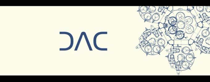 A banner displaying the letters "DAC" in blue next to a detailed technical blueprint sketch of a mechanical engine or industrial component.