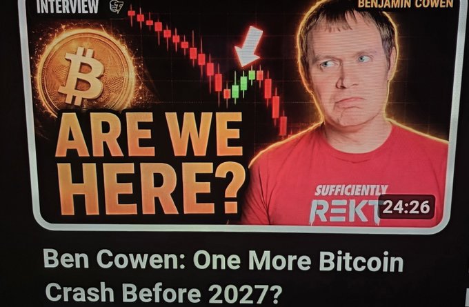 A YouTube thumbnail featuring Benjamin Cowen alongside a Bitcoin price chart, titled "ARE WE HERE?" with the headline "Ben Cowen: One More Bitcoin Crash Before 2027?" The post mocks Cowen's Bitcoin crash prediction, matching the thumbnail's skeptical framing of his market forecast.