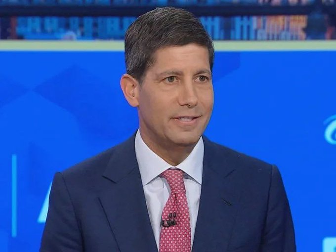 A male news anchor in a navy suit and pink tie appears on a blue broadcast background, likely delivering a report on the just-released Consumer Price Index (CPI) data showing a 3.4% year-over-year reading in line with expectations.