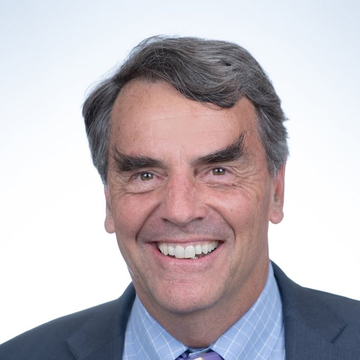 The image features a man wearing a suit and tie with a blue shirt, smiling for the camera. The caption below the photo reads "LATEST:Billionaire Tim Draper says quantum computing will “crack the banks long before it touches the blockchain,” arguing that legacy banking infrastructure is far more vulnerable and makes Bitcoin look like Fort Knox." This statement suggests that the man's opinion on the security of Bitcoin might be influenced by the idea that traditional banking systems are less secure than newer technologies such as quantum computing.