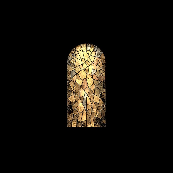 An arched window featuring stained glass with a mosaic of irregular amber, gold, and brown fragments, glowing warmly against a black background.