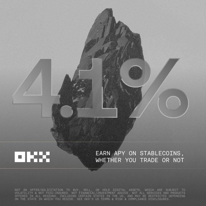 OKX advertisement promoting a "4.1% APY on stablecoins, whether you trade or not," featuring a large black crystalline rock against a gray background, with the OKX logo and a disclaimer about not being an offer of financial advice.